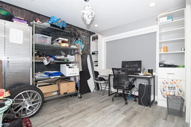 a view of a workspace with furniture and a window