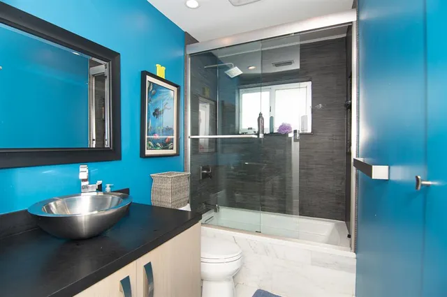 a view of a workspace with furniture and wooden floor