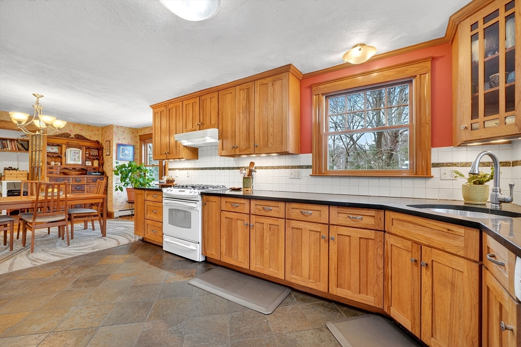 49 Pond Street Westwood, MA 02090 - Photo 12 of 36 a kitchen with stainless steel appliances granite countertop a stove sink and cabinets