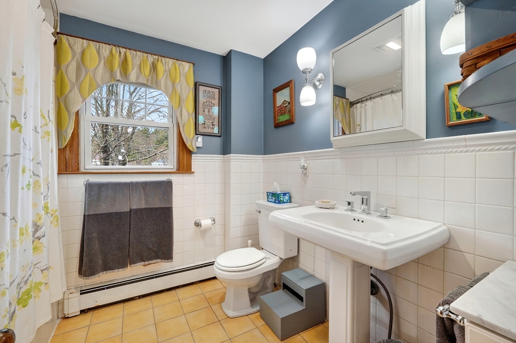 49 Pond Street Westwood, MA 02090 - Photo 14 of 36 a bathroom with a sink a mirror and a toilet