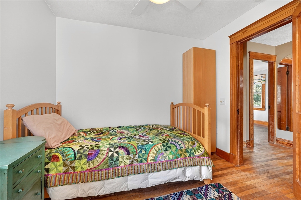 49 Pond Street Westwood, MA 02090 - Photo 17 of 36 a bedroom with a bed and a dresser
