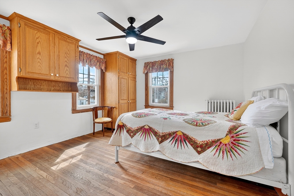 49 Pond Street Westwood, MA 02090 - Photo 19 of 36 a bedroom with a bed and wooden floor