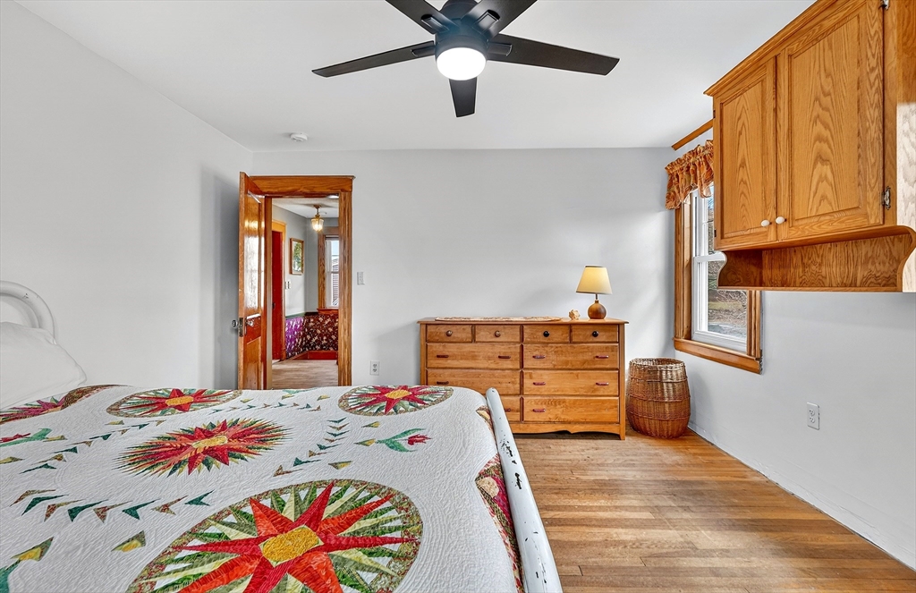 49 Pond Street Westwood, MA 02090 - Photo 20 of 36 a bedroom with a bed and a chandelier