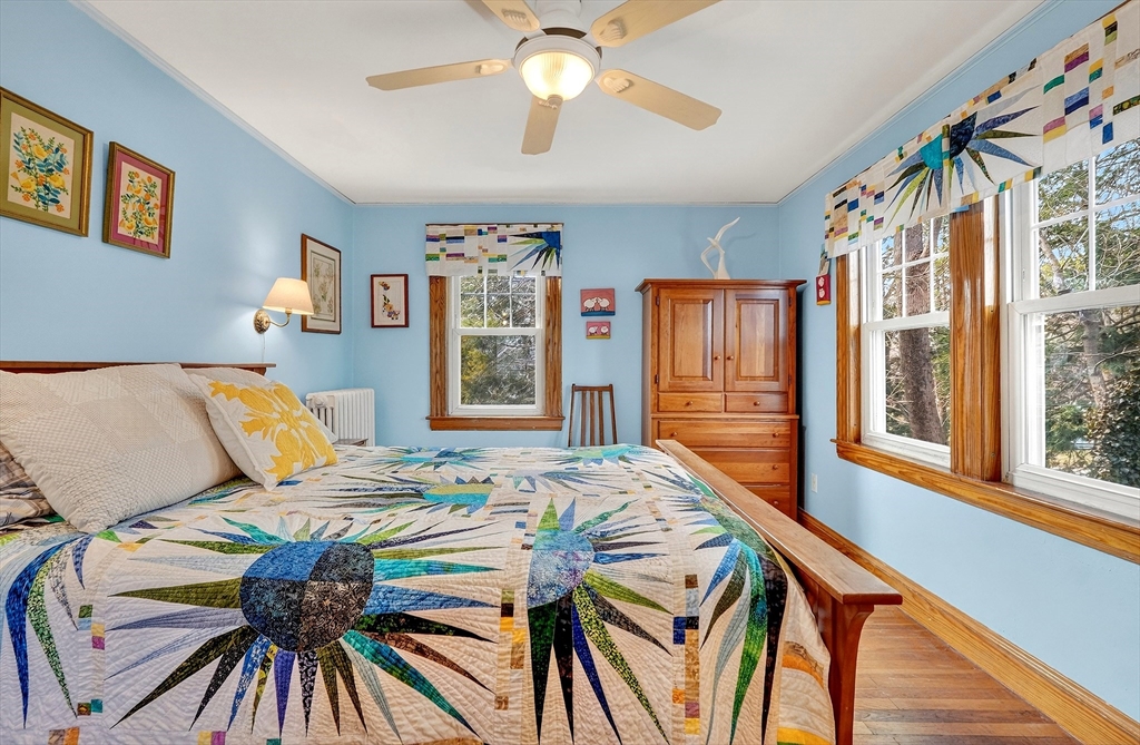 49 Pond Street Westwood, MA 02090 - Photo 22 of 36 a bedroom with a bed and a chandelier