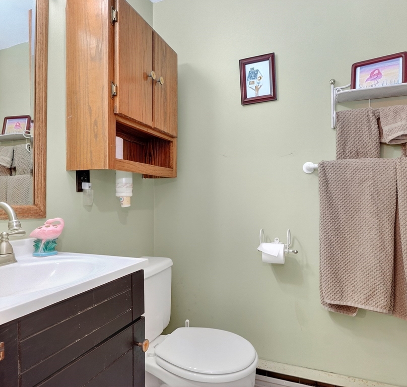 49 Pond Street Westwood, MA 02090 - Photo 25 of 36 a bathroom with a sink a toilet and mirror