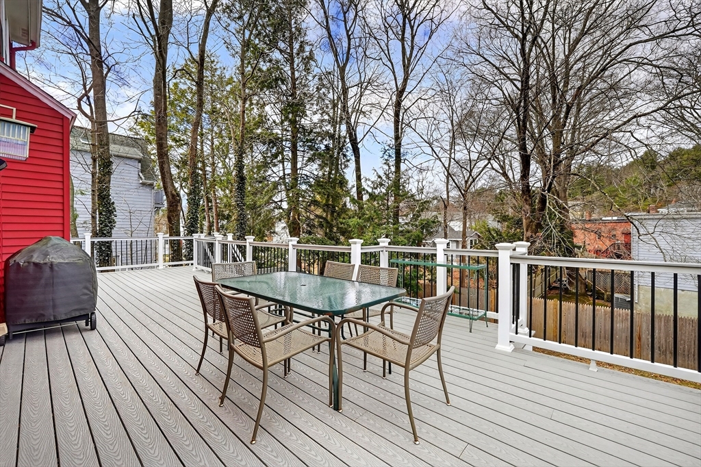 49 Pond Street Westwood, MA 02090 - Photo 26 of 36 a view of a roof deck with table and chairs and wooden floor