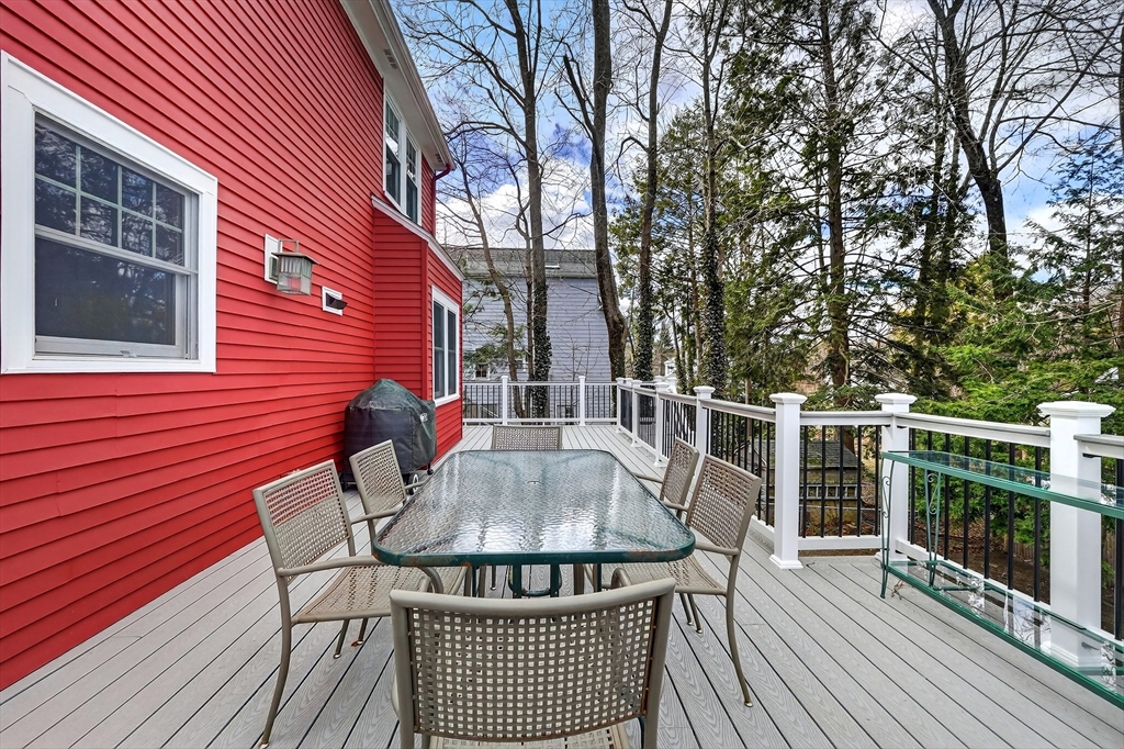 49 Pond Street Westwood, MA 02090 - Photo 27 of 36 a view of a roof deck with table and chairs with wooden floor and fence
