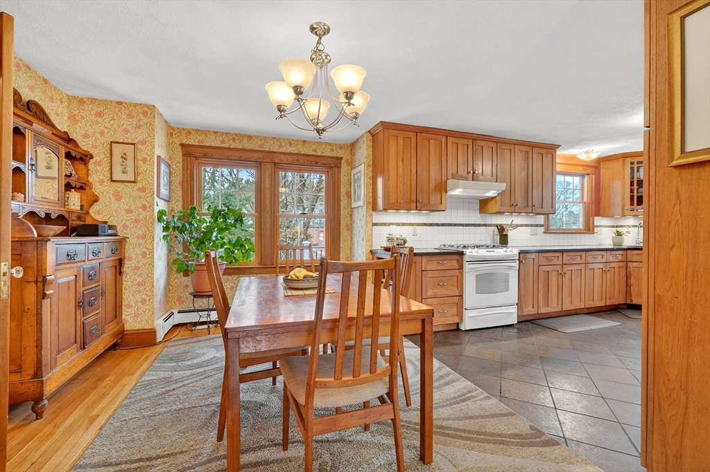 49 Pond Street Westwood, MA 02090 - Photo 7 of 36 a view of a dining room with furniture a chandelier and wooden floor