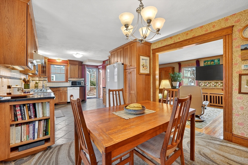 49 Pond Street Westwood, MA 02090 - Photo 8 of 36 a view of a dining room with furniture wooden floor and chandelier