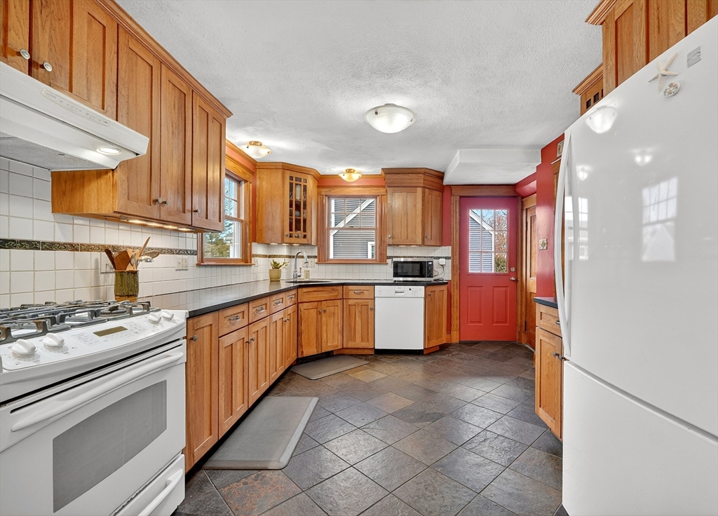 49 Pond Street Westwood, MA 02090 - Photo 10 of 36 a large kitchen with stainless steel appliances and cabinets