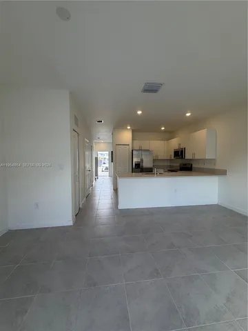 a view of a kitchen with a sink and a stove top oven