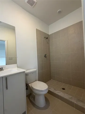 a bathroom with a shower a toilet and a sink