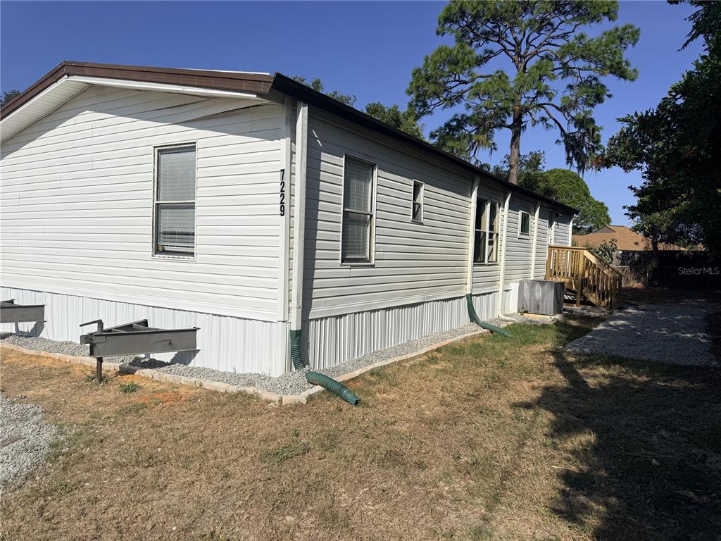 7229 Allyson Street Port Richey, FL 34668 - Photo 1 of 11 a backyard of a house with table and chairs