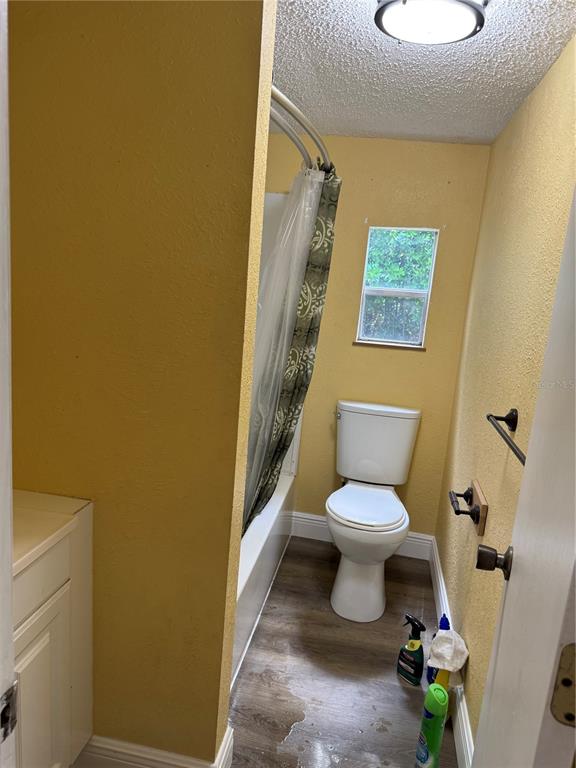 7229 Allyson Street Port Richey, FL 34668 - Photo 7 of 11 a bathroom with a toilet and a shower