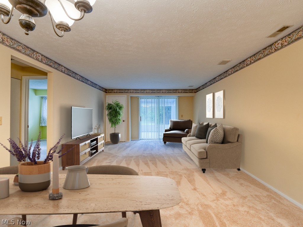8941 West Ridge Road, Unit A Elyria, OH 44035 - Photo 12 of 30 dining room/Living room with light colored carpet, a chandelier, and a textured ceiling-digitally staged