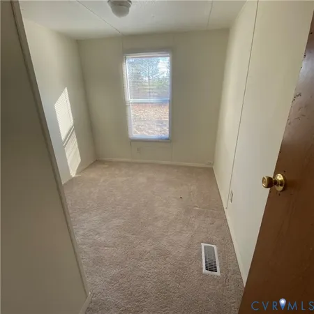a view of a glass door with a yard from a window