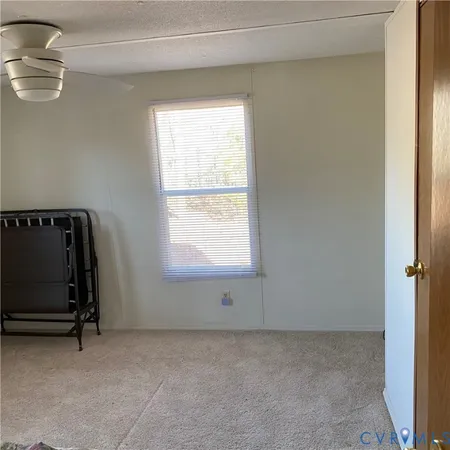 a room with a wooden floor and a window