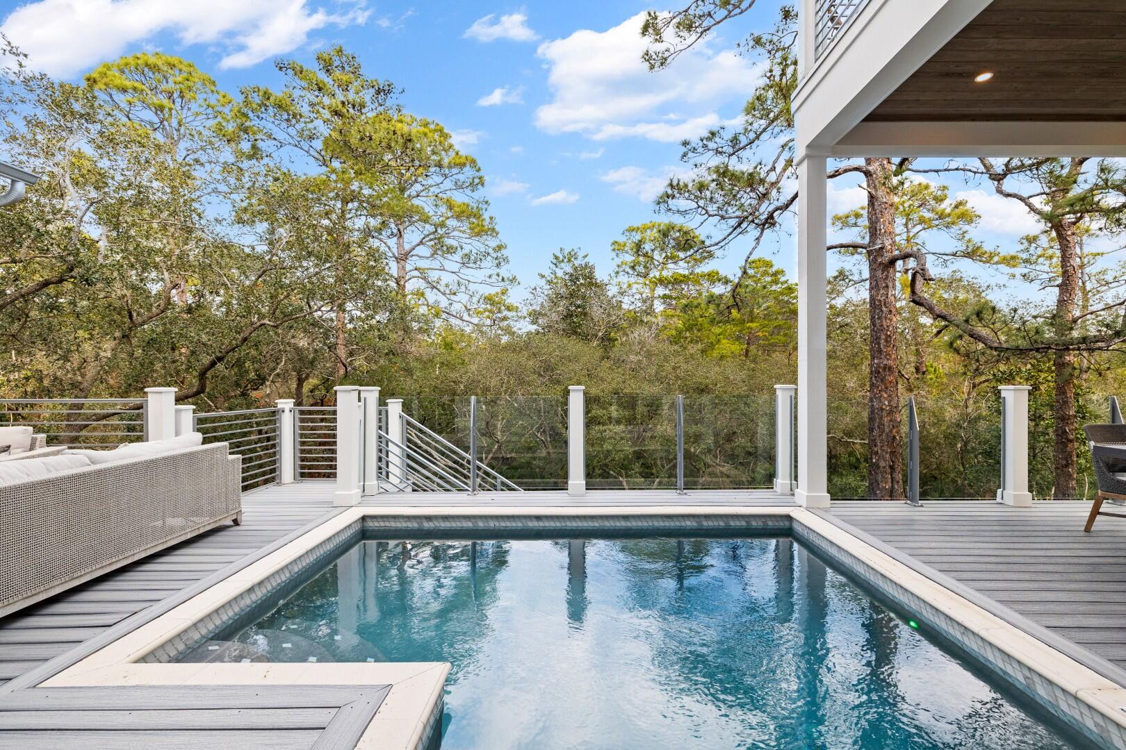 23 Spotted Dolphin Road Santa Rosa Beach, FL 32459 - Photo 17 of 59 a view of a balcony with floor to ceiling windows and wooden floor