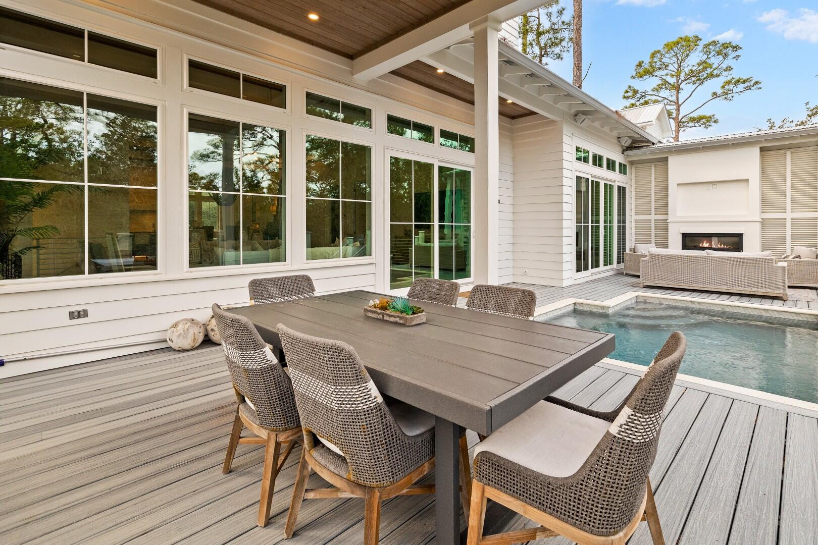 23 Spotted Dolphin Road Santa Rosa Beach, FL 32459 - Photo 6 of 59 a view of a patio with a table and chairs