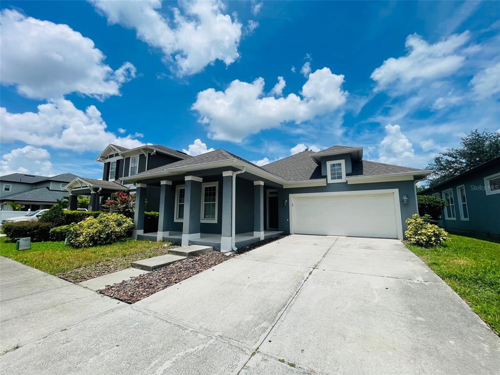 13645 Riggs Way Windermere, FL 34786 - Photo 2 of 12 a front view of a house with garden