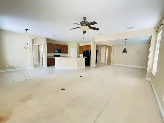a view of a kitchen with a sink and a refrigerator