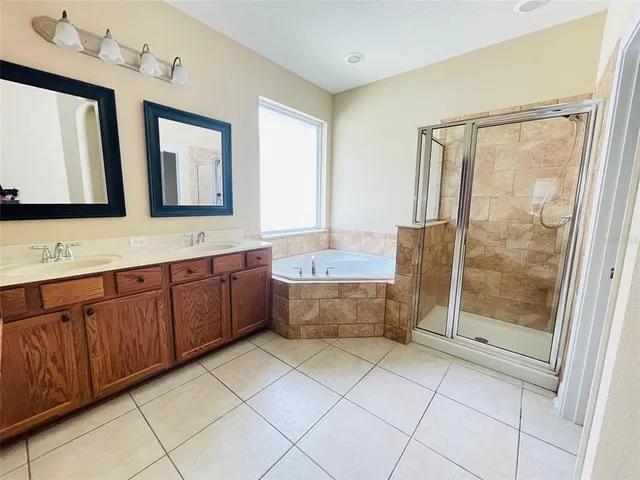 a bathroom with a granite countertop sink a mirror and a bathtub
