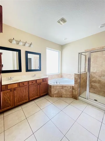 a large spacious bathroom with a granite countertop bathtub sink and mirror
