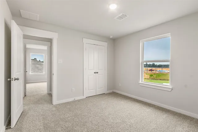 a view of an empty room and closet area