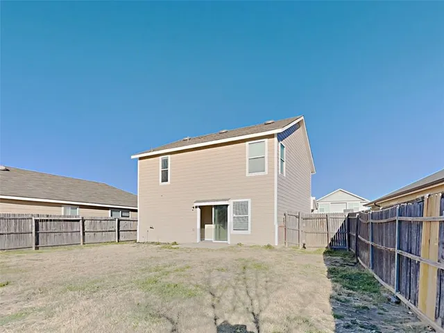 a view of house with backyard and deck