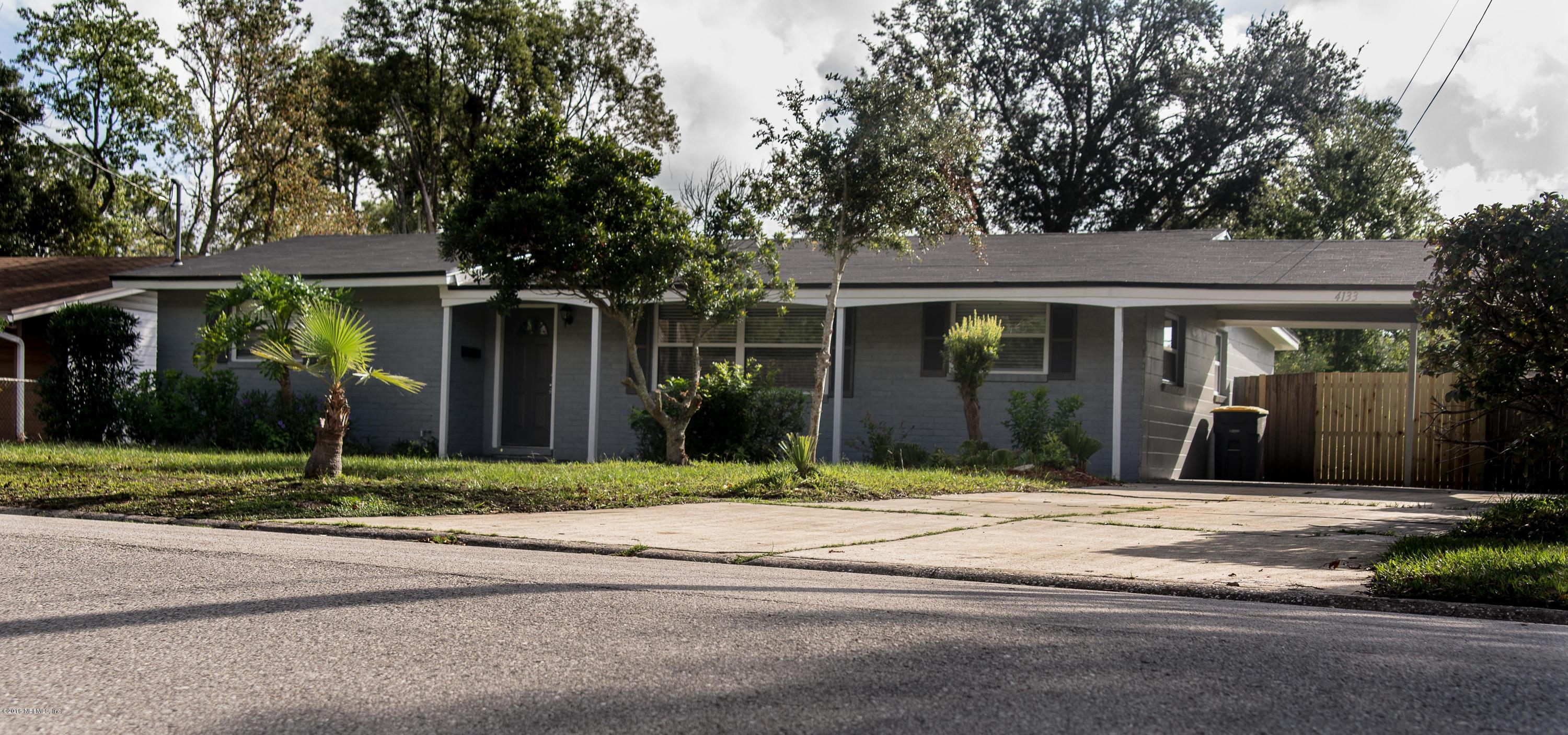 4133 Dayrl Road Jacksonville, FL 32207 - Photo 1 of 21 a view of a house with a yard and large tree