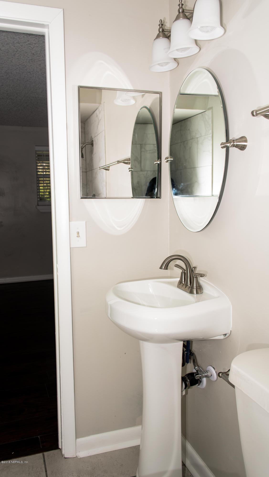 4133 Dayrl Road Jacksonville, FL 32207 - Photo 11 of 21 a bathroom with a sink and mirror