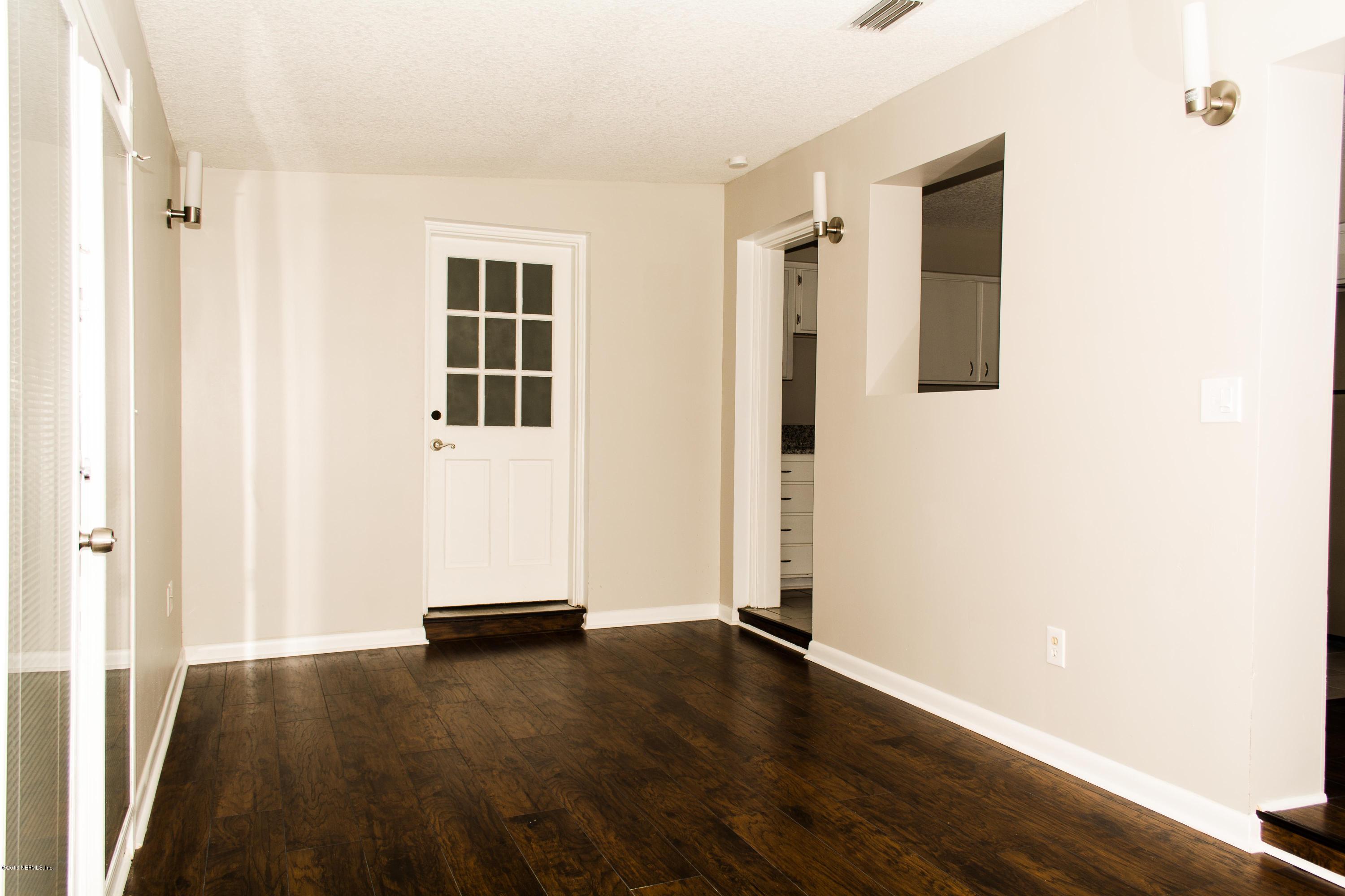 4133 Dayrl Road Jacksonville, FL 32207 - Photo 16 of 21 an empty room with wooden floor and windows