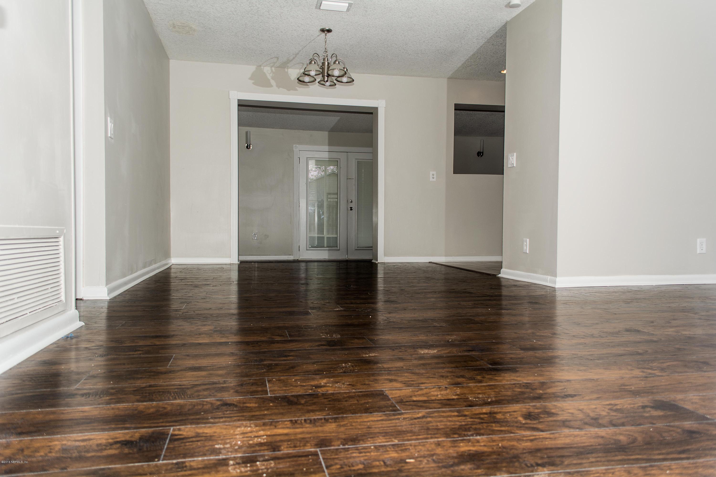 4133 Dayrl Road Jacksonville, FL 32207 - Photo 3 of 21 a view of a room with wooden floor and staircase
