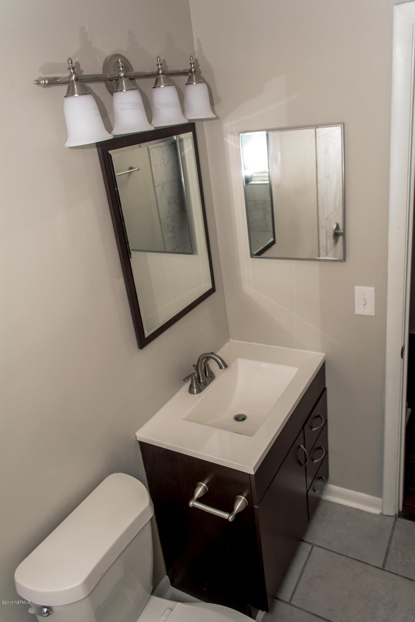4133 Dayrl Road Jacksonville, FL 32207 - Photo 7 of 21 a bathroom with a sink toilet and mirror