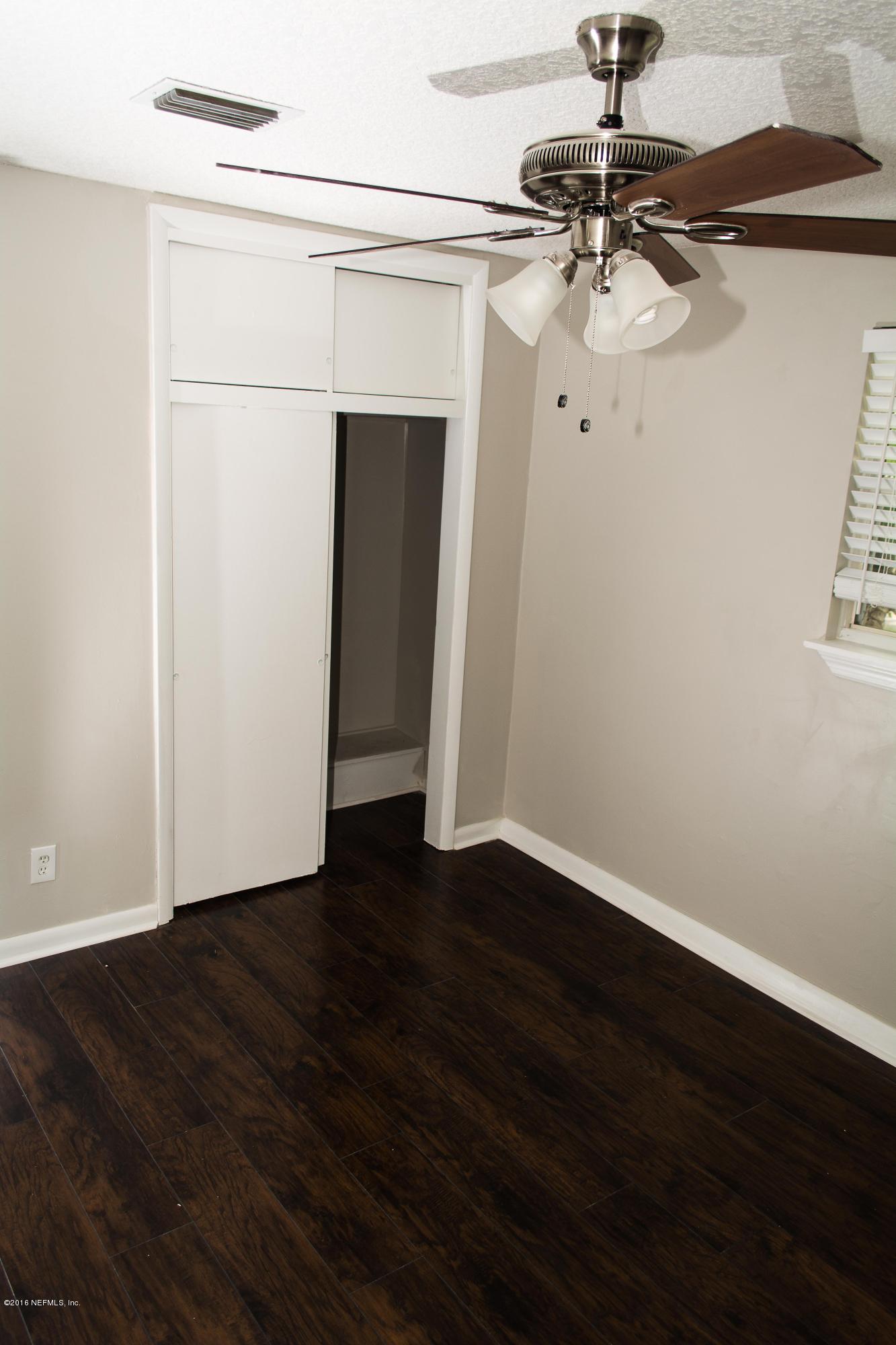 4133 Dayrl Road Jacksonville, FL 32207 - Photo 8 of 21 a view of a room with wooden floor closet and windows