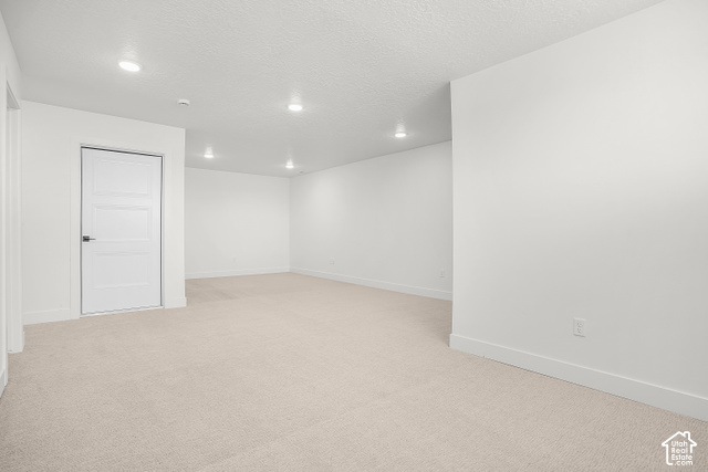 1631 West Century Lane, Unit B Mapleton, UT 84664 - Photo 18 of 23 Recessed lighting illuminates this carpeted room with white walls and a paneled door