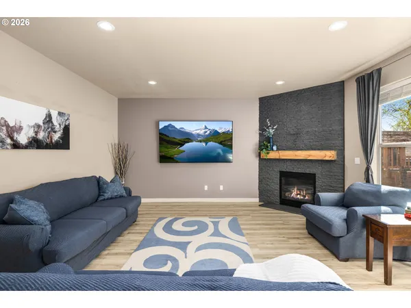 a living room with furniture a fireplace and a flat screen tv