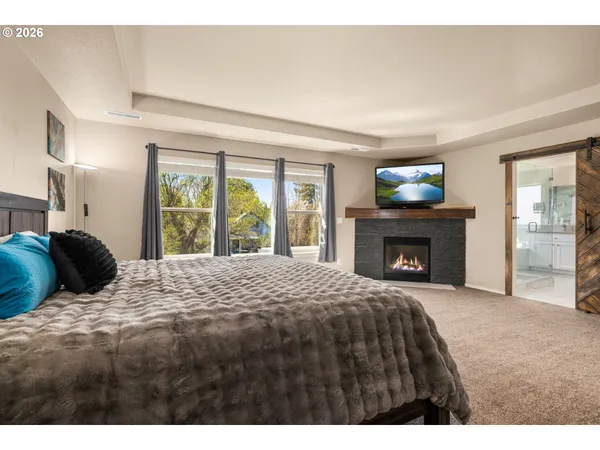 a bedroom with a bed and a fireplace
