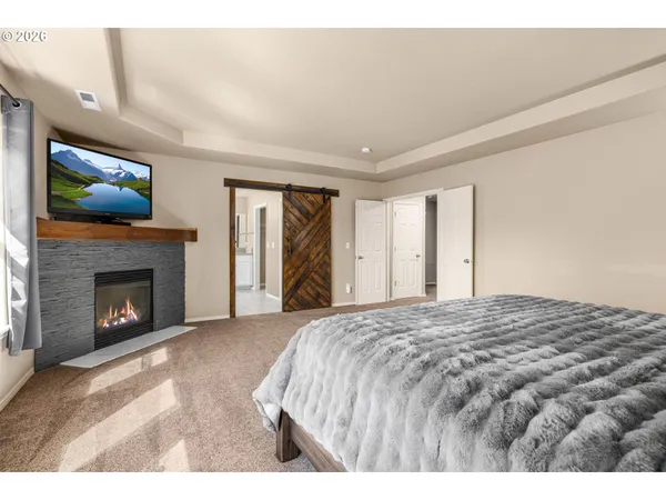 a bedroom with a bed and a fireplace