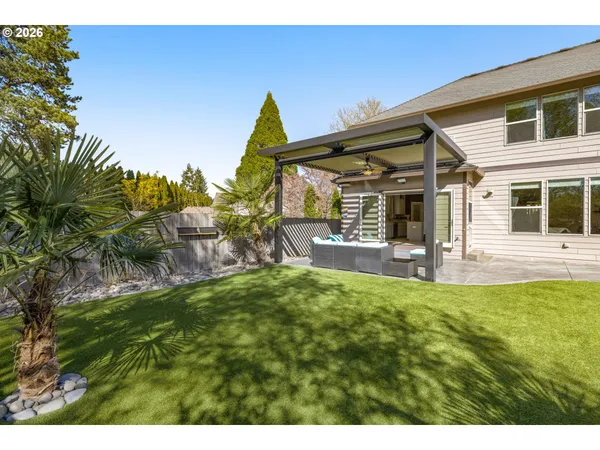 a backyard of a house with table and chairs