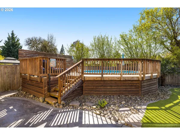 a view of balcony with wooden floor and fence