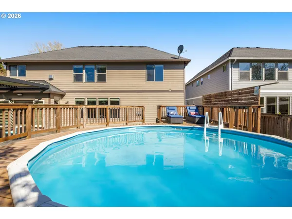a swimming pool with outdoor seating and yard