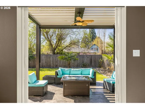 a view of a patio with table and chairs and a potted plant