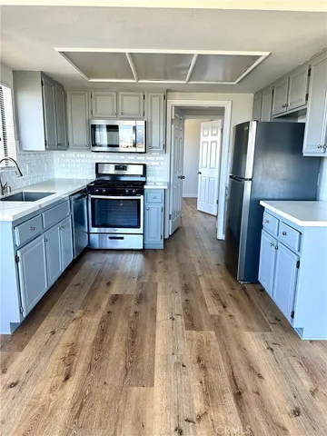 a kitchen with granite countertop a refrigerator and a stove