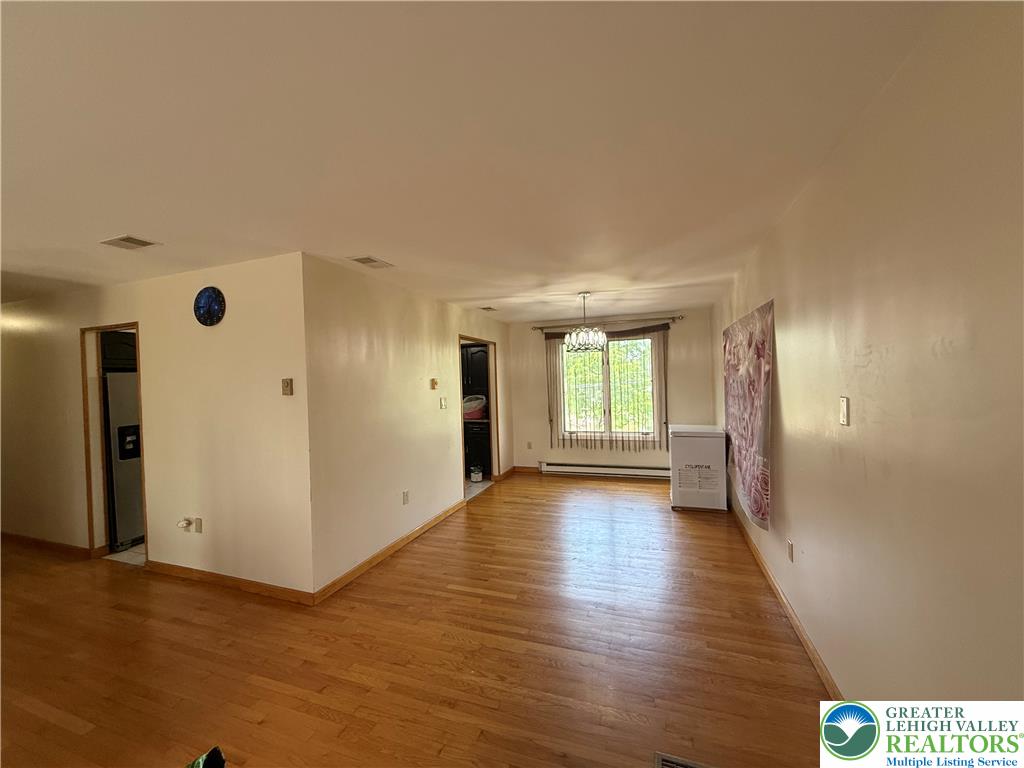 1150 Ridge Avenue Allentown, PA 18102 - Photo 4 of 14 Rich hardwood floors flow through this welcoming space, anchored by a naturally lit dining area.