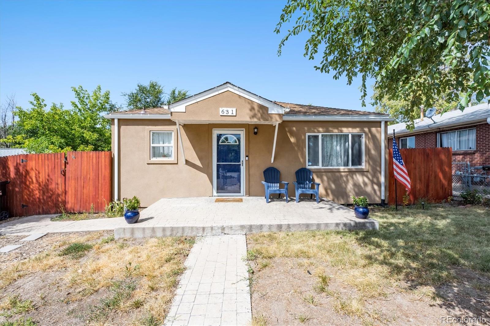 a view of a house with wooden fence