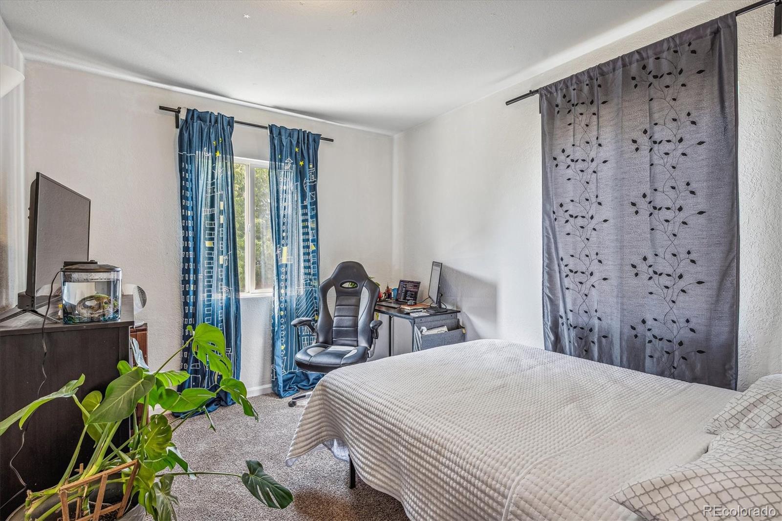 631 South Raleigh Street Denver, CO 80219 - Photo 11 of 15 a bedroom with a bed and a chair