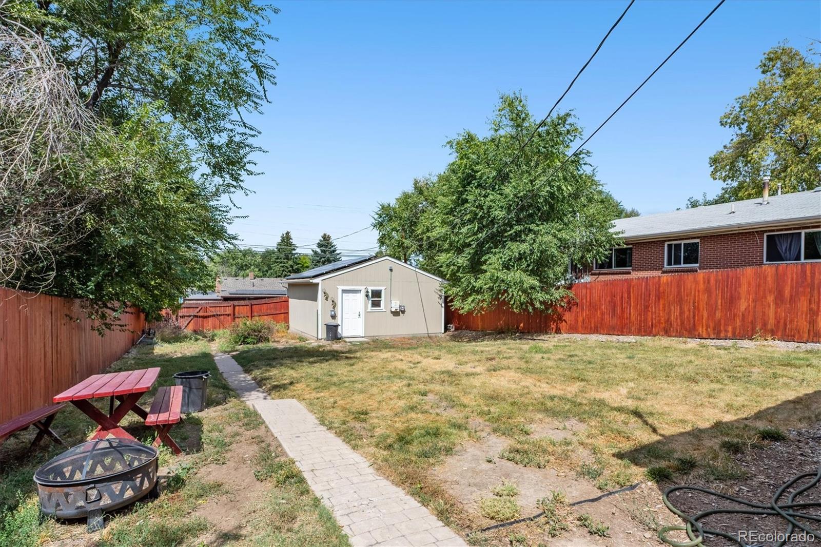 631 South Raleigh Street Denver, CO 80219 - Photo 12 of 15 a backyard of a house with table and chairs