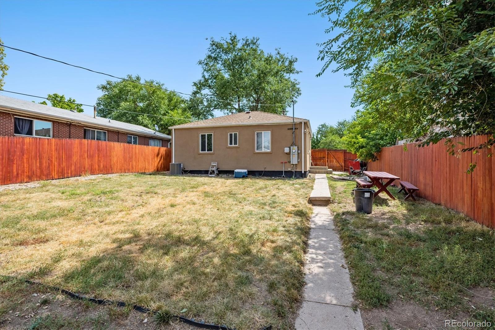 631 South Raleigh Street Denver, CO 80219 - Photo 13 of 15 a view of a backyard with potted plants and large tree