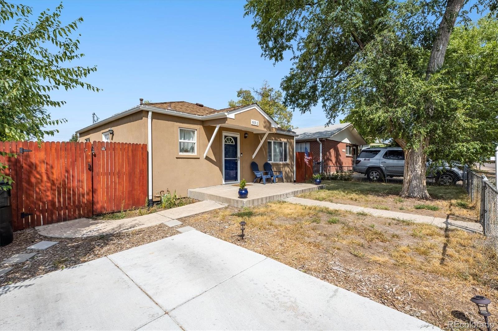 631 South Raleigh Street Denver, CO 80219 - Photo 2 of 15 a front view of a house with a yard